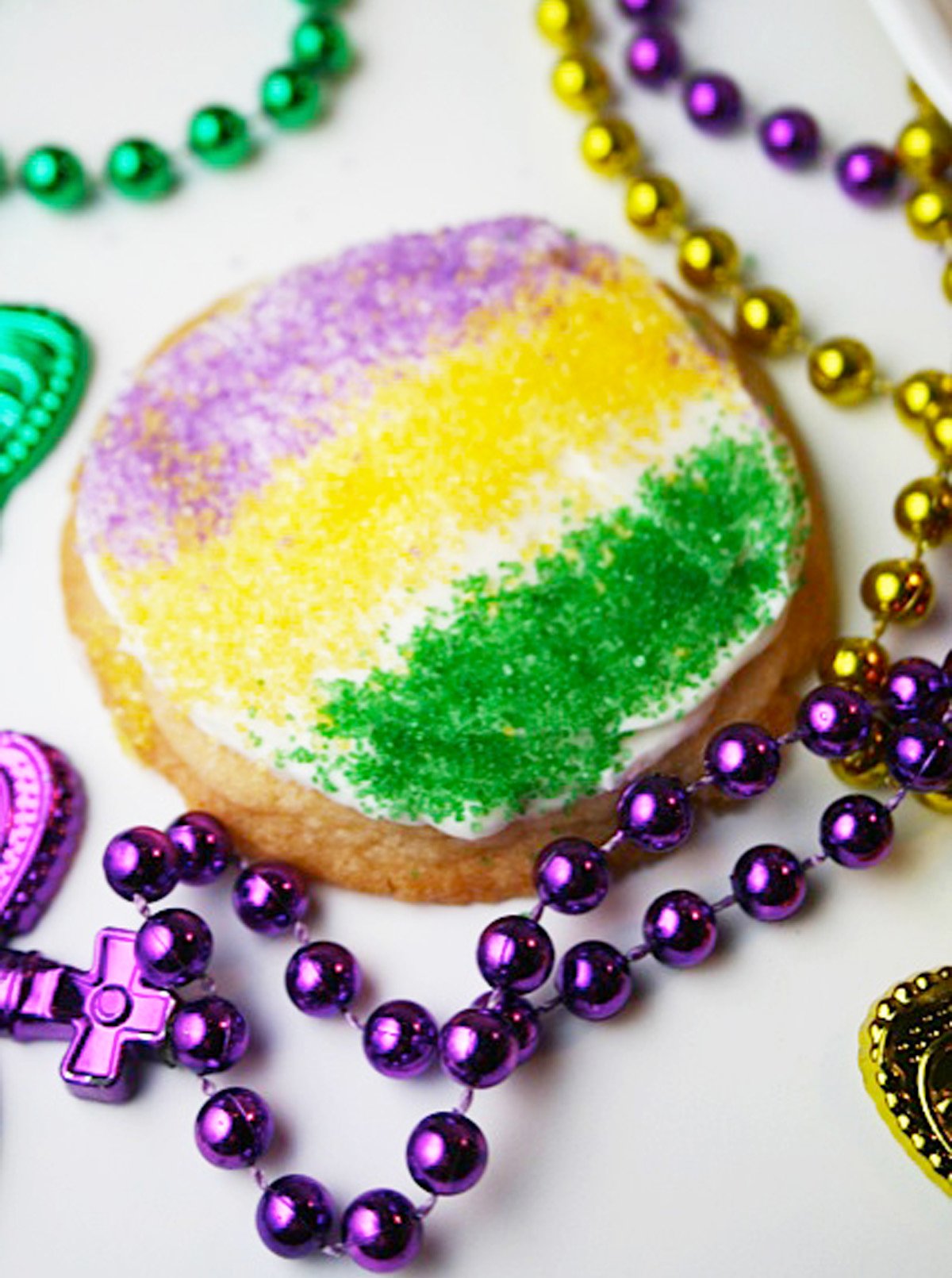 Sugar cookies with purple, green and yellow sprinkles.