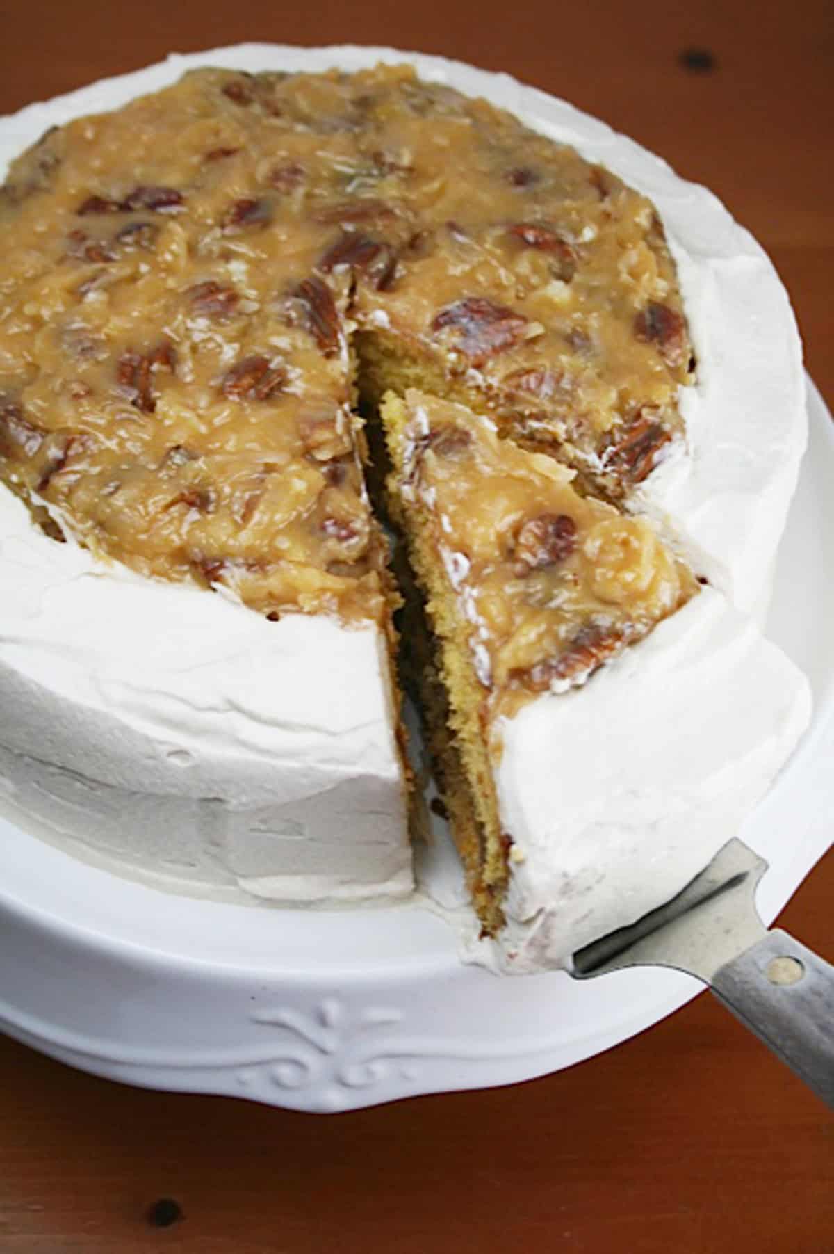 Mardi Gras party cake with butterscotch filling on a white cake stand.