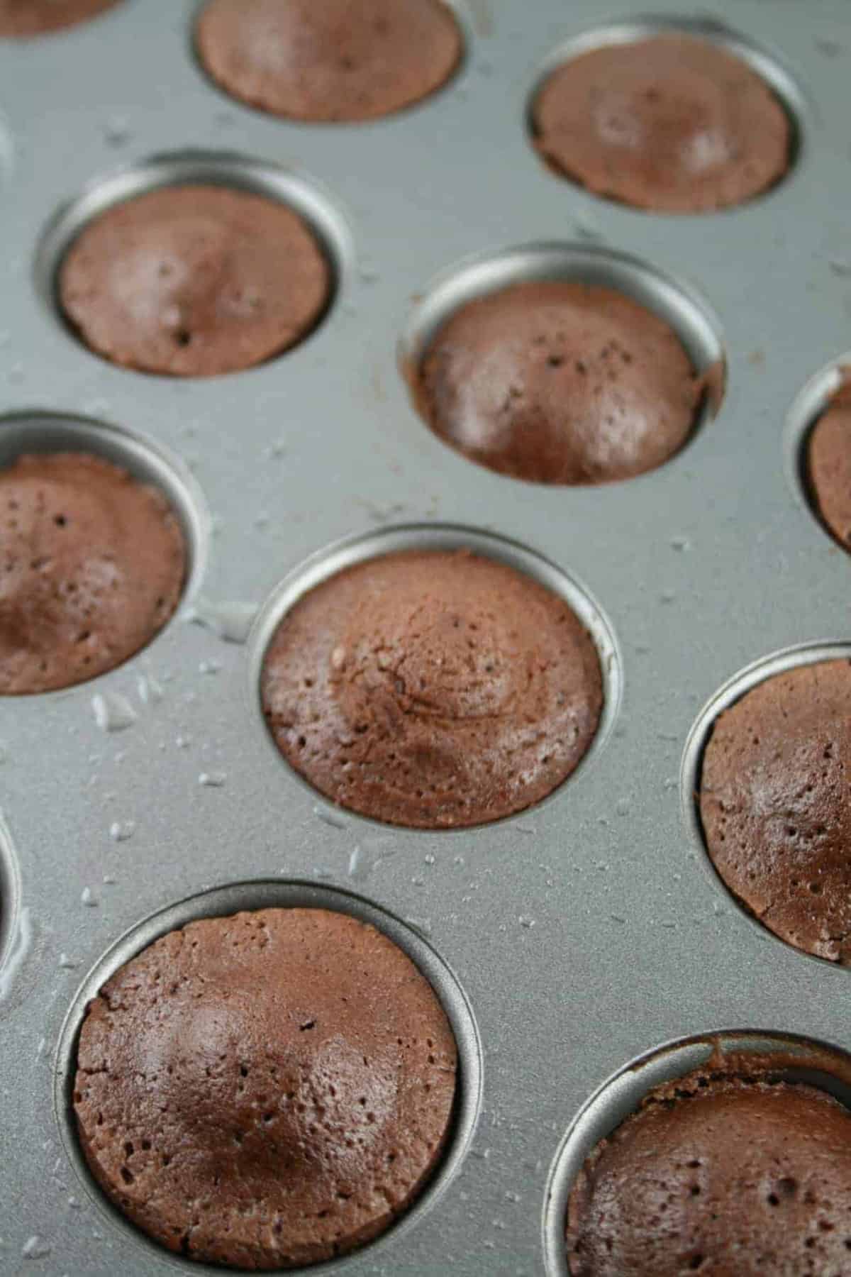 cooked mini muffins in muffin pan.