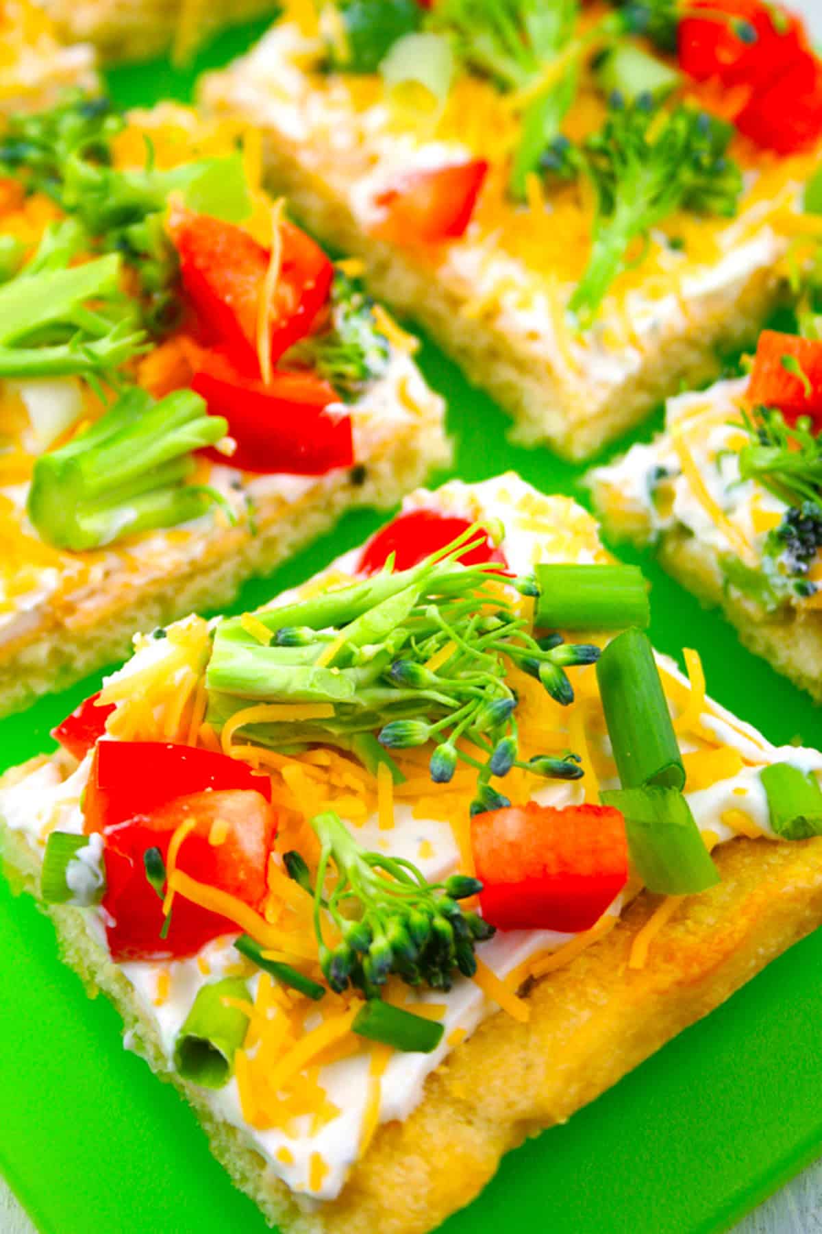 Cold veggie pizza cut into squares.