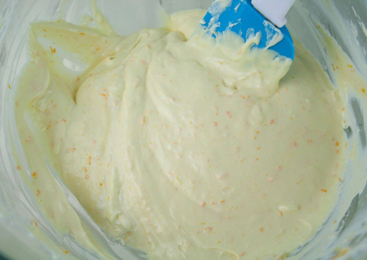 Cheesecake batter in a bowl with spatula.