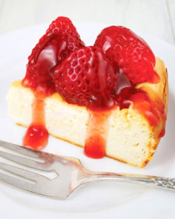 One slice of low carb chesecake with strawberry topping.
