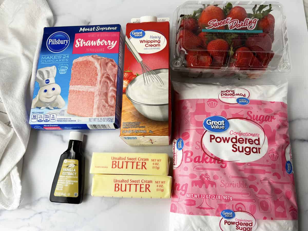 All the ingredients needed to make strawberry cupcakes set on the kitchen counter.
