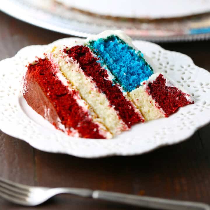 Piece of cake cut from an American flag surprise inside layer cake.