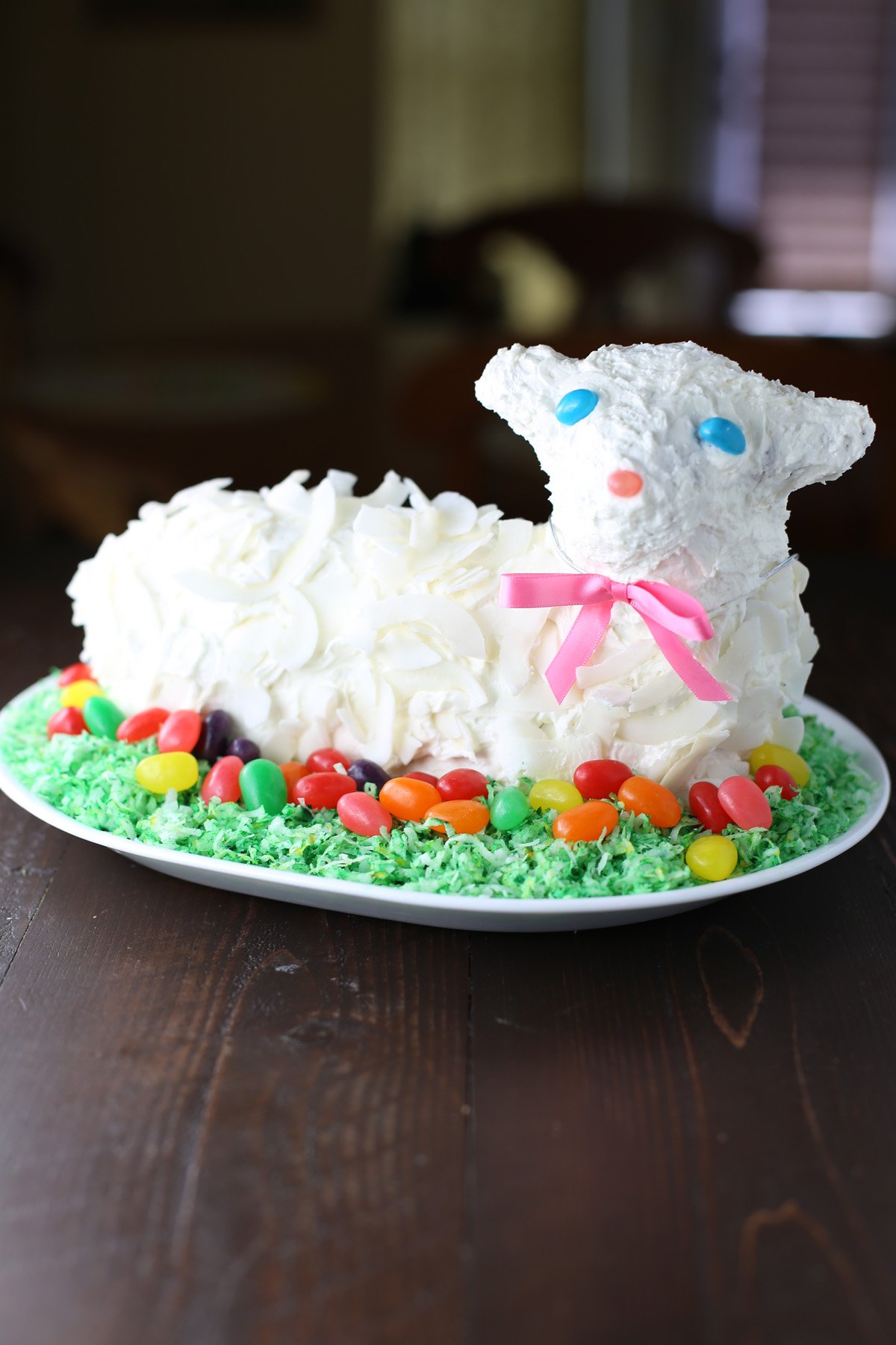 Frosted Easter lamb cake on a white plate.