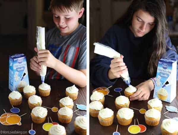 Kids frosting Solar System Cupcakes