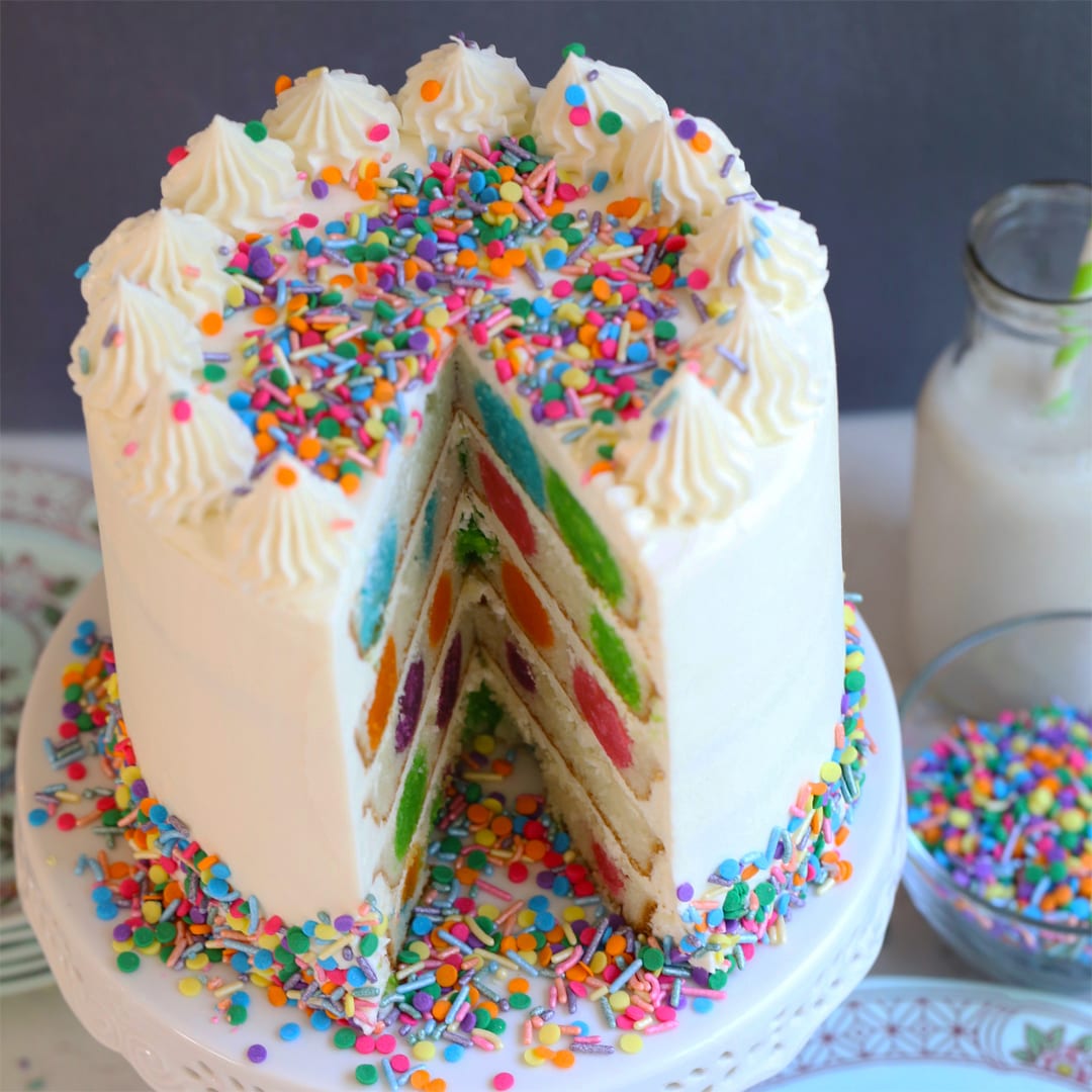 Vanilla cake with surprise inside polka dots plus buttercream and sprinkles