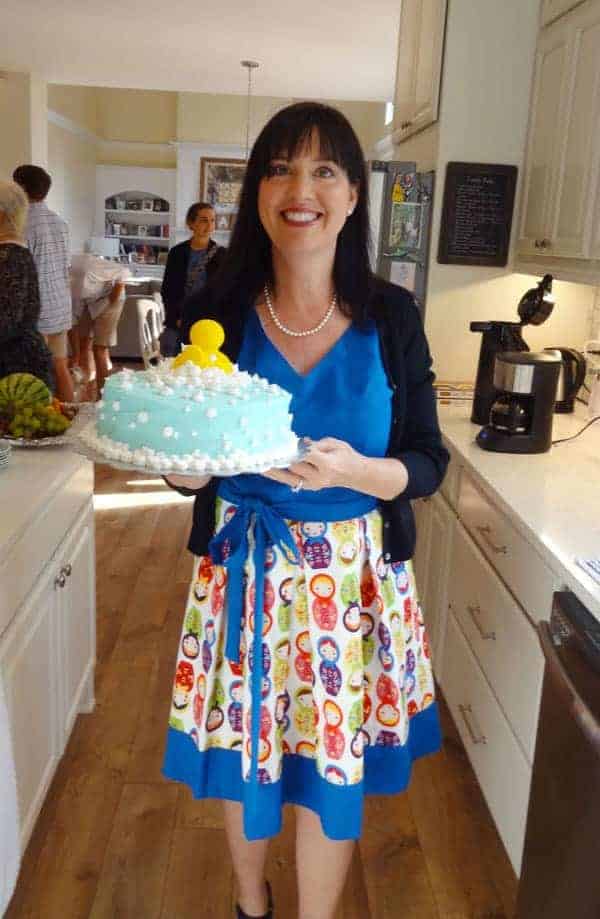 Girl hold Baby Shower Cake for boy baby.