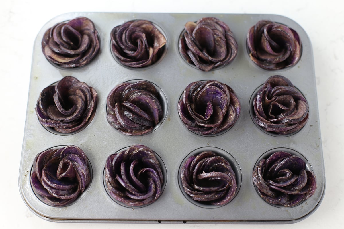 Purple potato roses in a mini muffin pan.