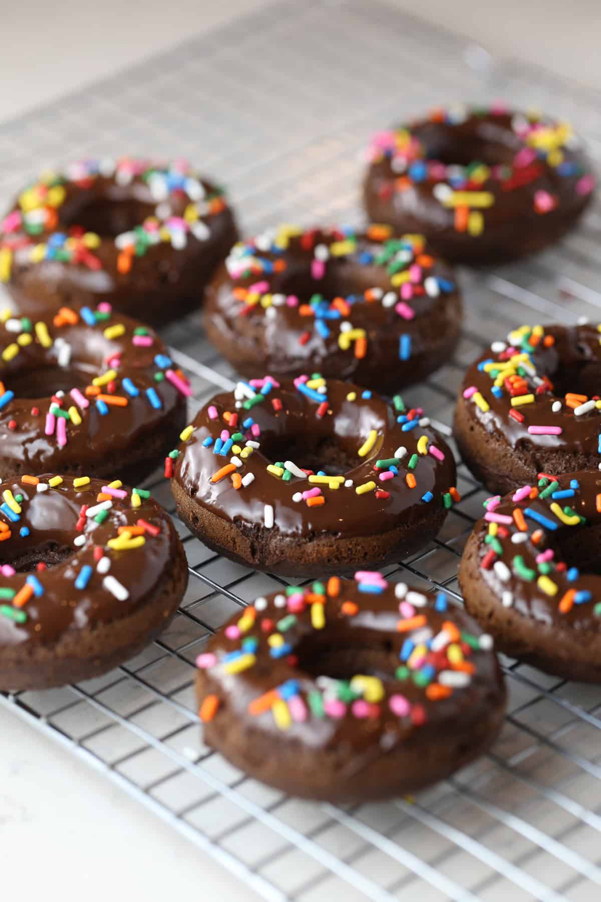 Cooling rack filled with chocolate frosted low carb donuts.