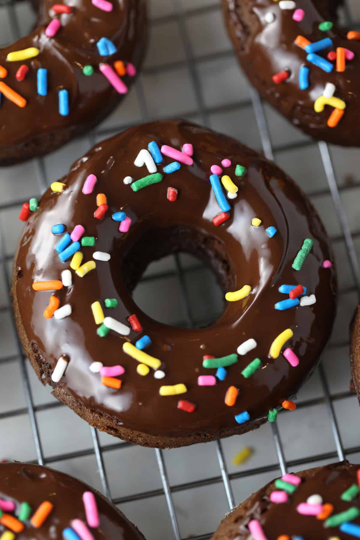 Keto donuts with chocolate frosting and sprinkles.