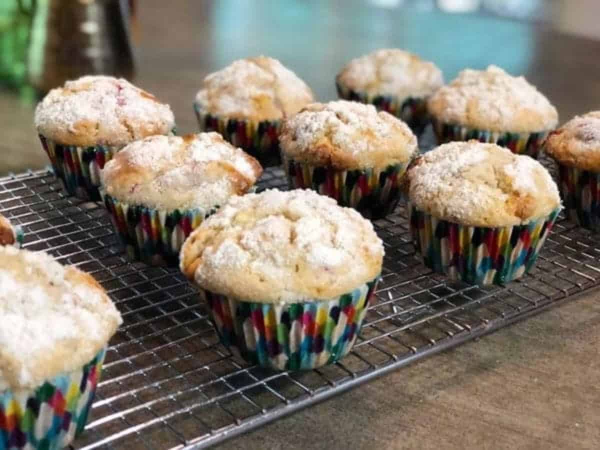 White chocolate raspberry muffins on a metal cooling rack