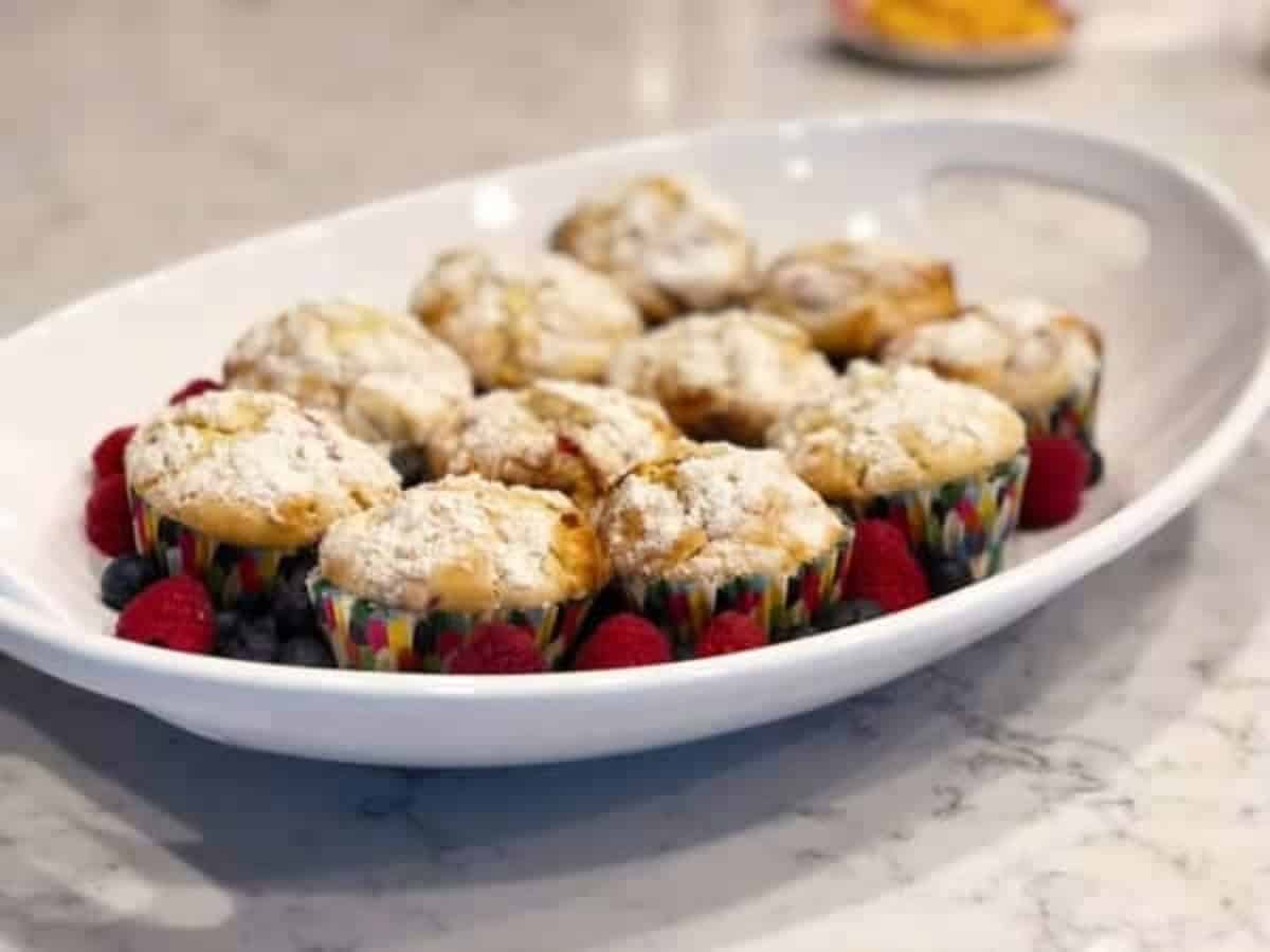 White chocolate raspberry muffins on a white plate.