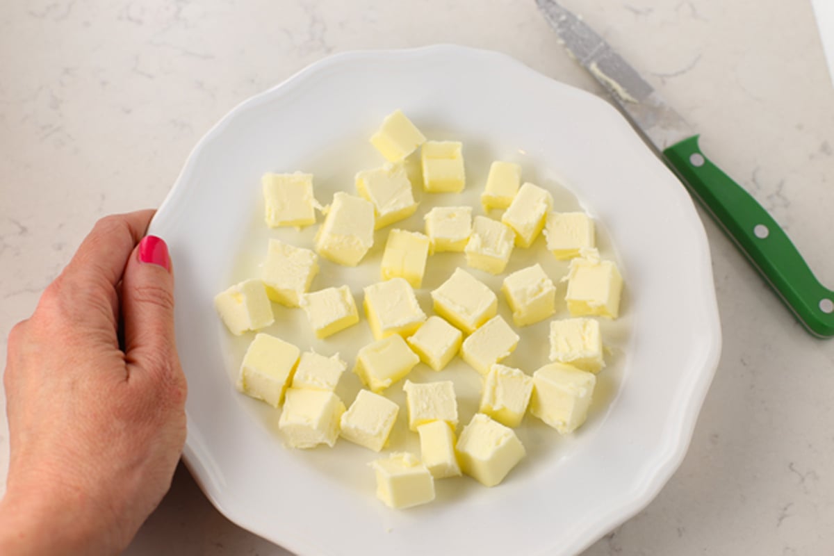 Cubed butter on a white plate.