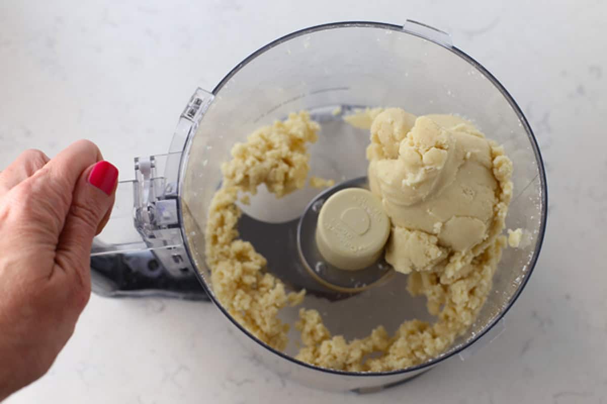 Making shortbread crust dough in a food processor.
