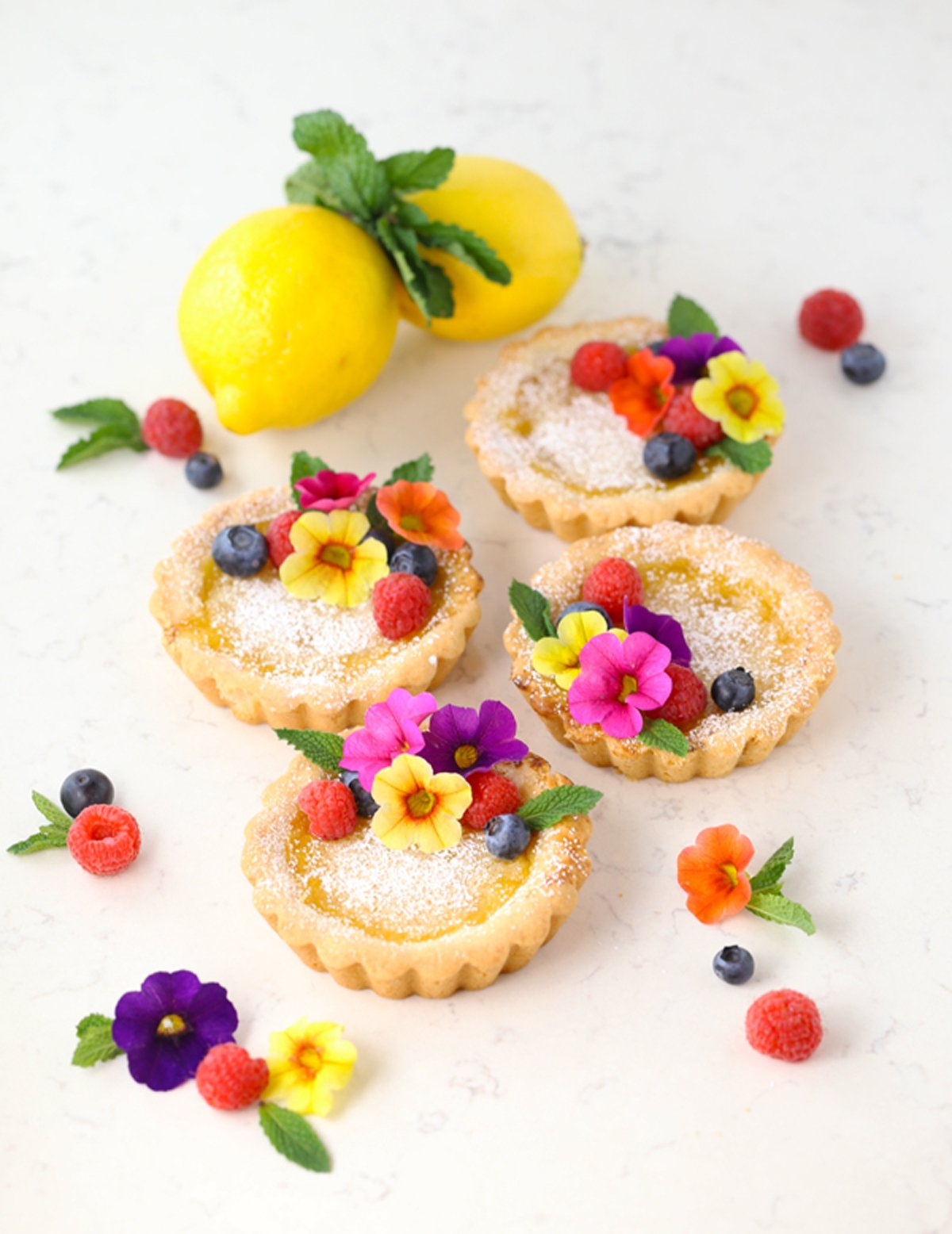 Homemade mini lemon tarts on a counter.
