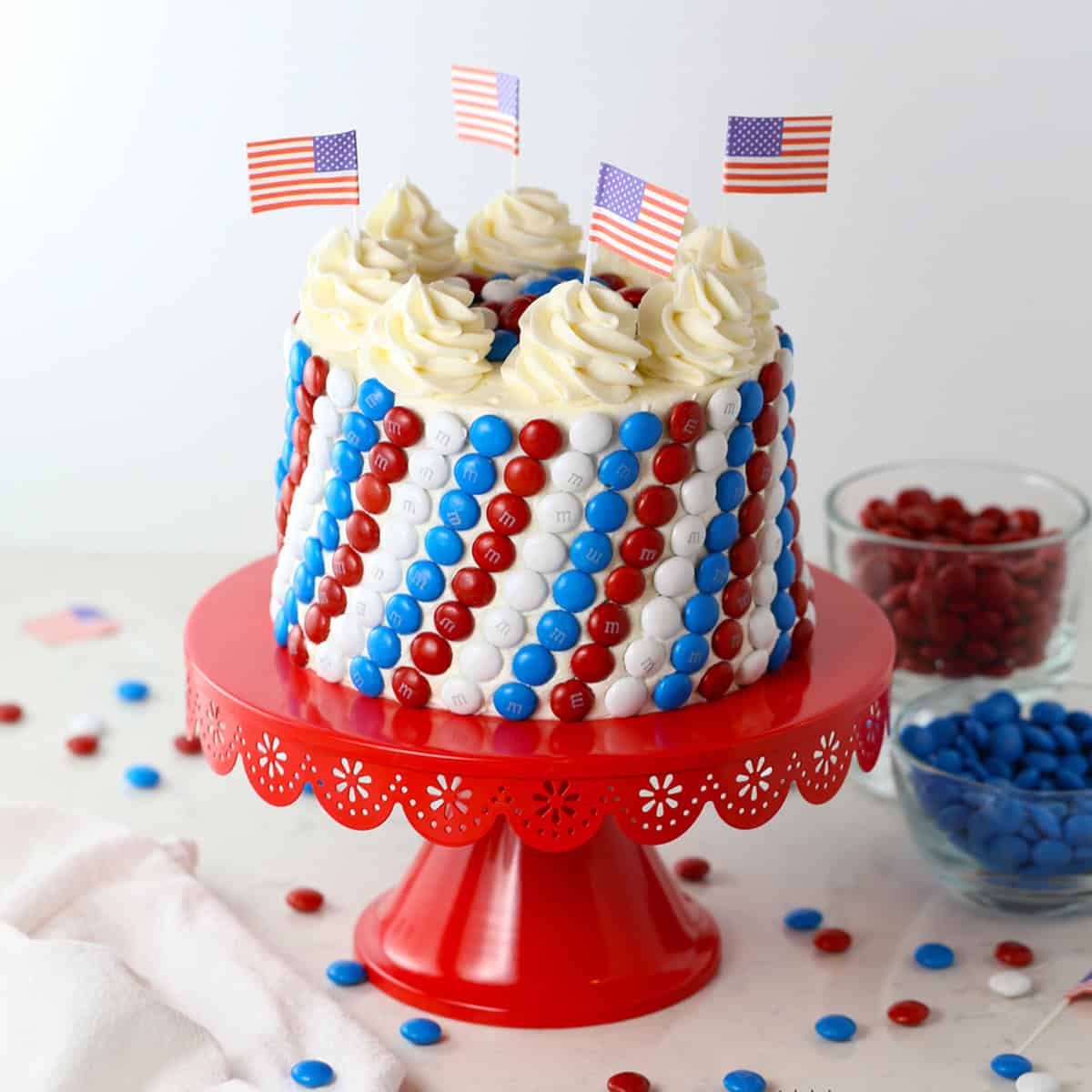 Finished red, white, and blue July 4th cake decorated with chocolate candies and buttercream frosting.