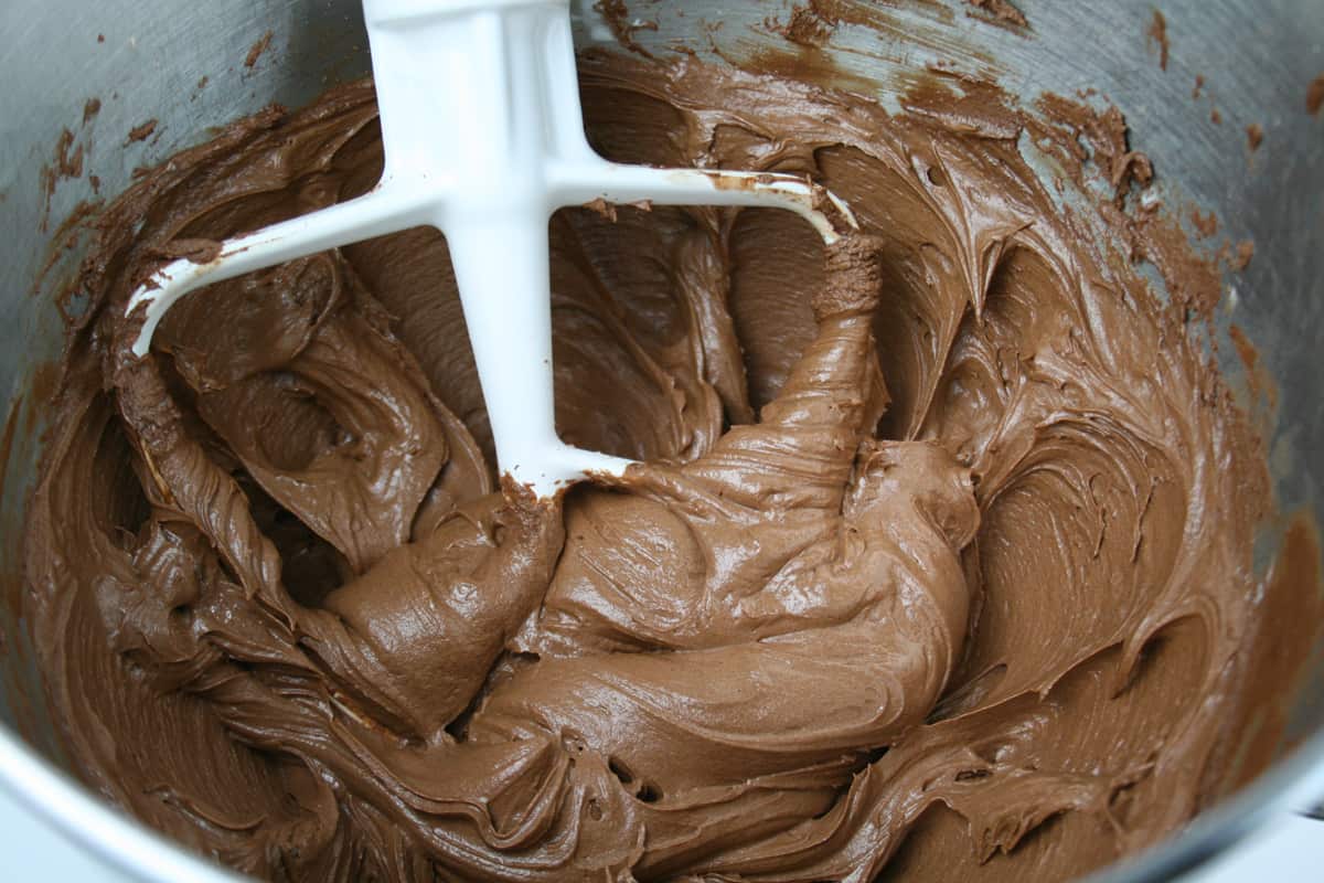 Chocolate frosting in a mixing bowl.