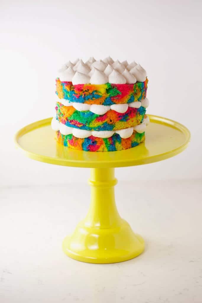 Tie dye cake on yellow cake stand