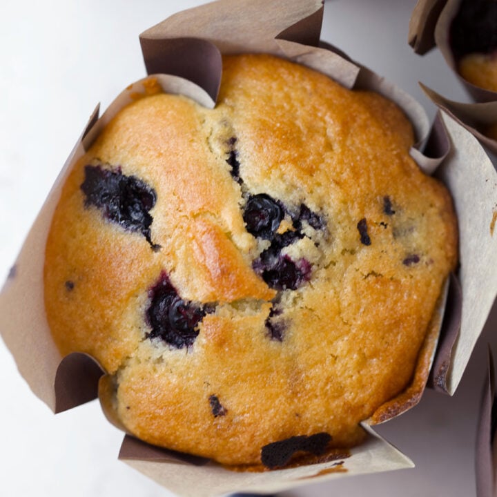 Close up of the top of a fresh blueberry muffin.