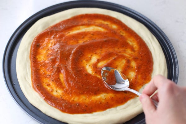 Press pizza dough onto pan