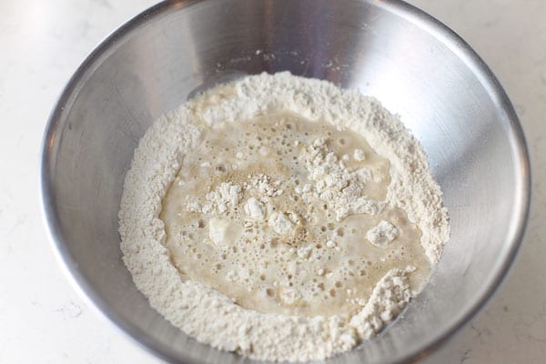 Add warm water and oil to pizza dough mix