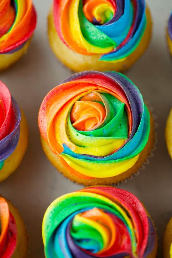 Row of colored frosting cupcakes