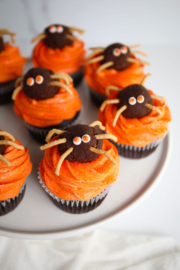 Halloween Spider chocolate cupcakes with orange buttercream frosting chocolate truffle spiders on top.