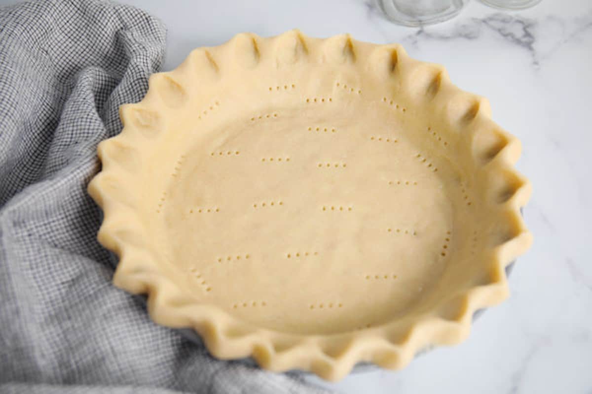 Homemade pie crust in a pie plate before baking.
