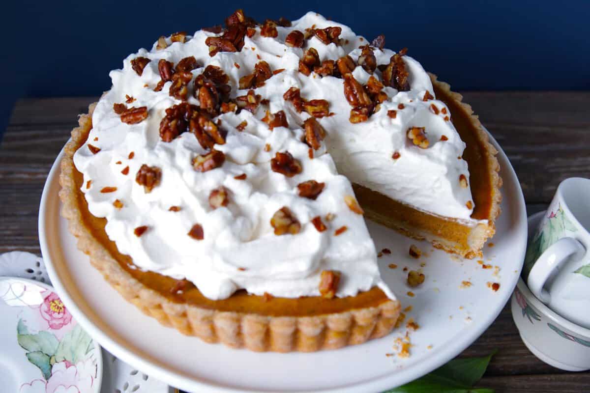 Turtle pumpkin tart with whipped cream and pecan toffee