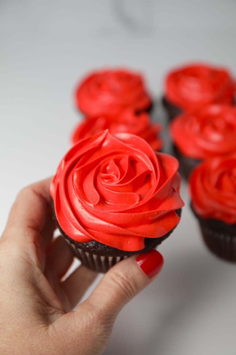 Red colored sweetenend condensed milk buttercream rose cupcakes