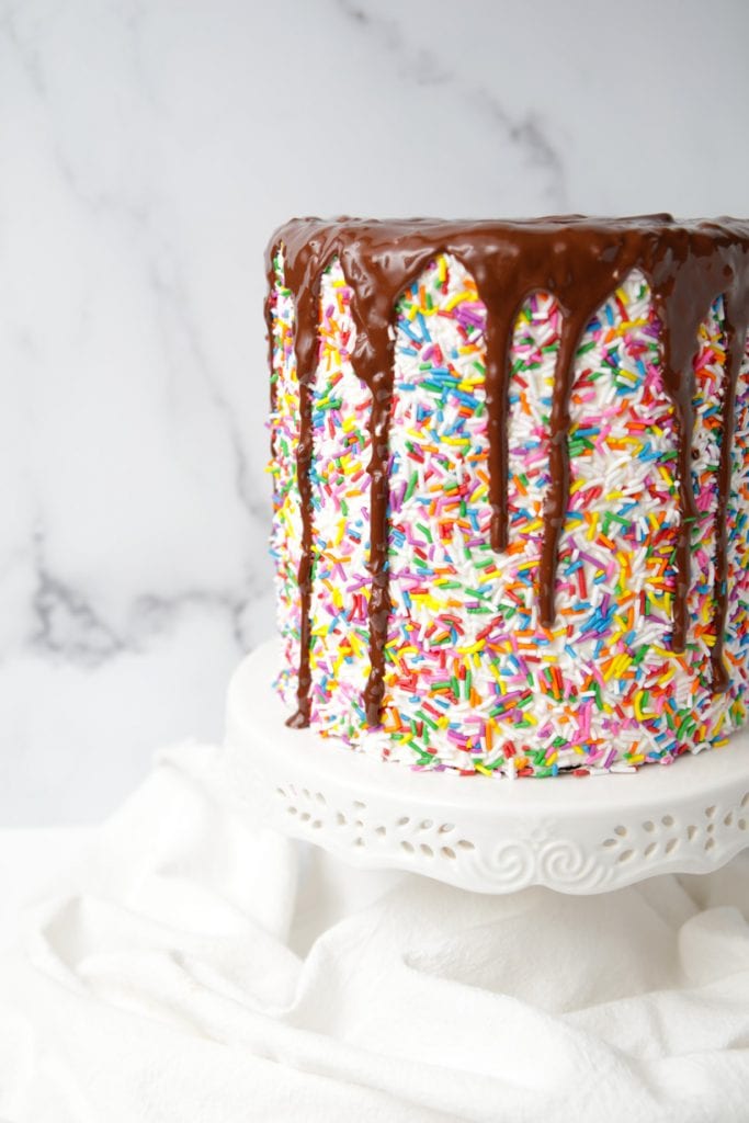 Rainbow Sprinkles Chocolate Drip Cake - Mom Loves Baking