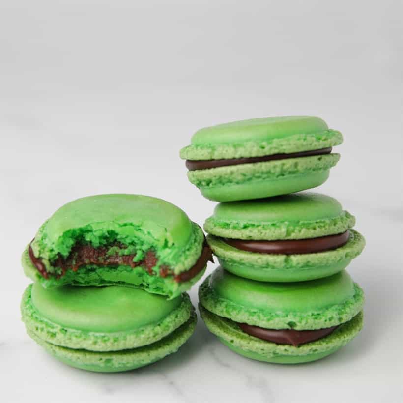 Stack of green macaron cookies with bite taken out