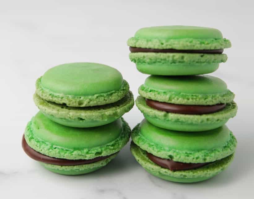 Stack of chocolate filled mint flavored macaron cookies