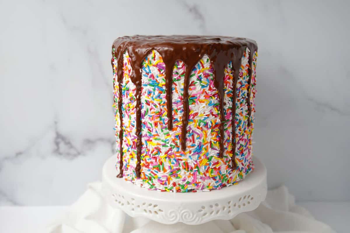 Chocolate ganache drizzle on sprinkles cake