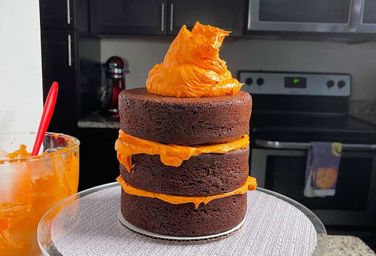 Frosting halloween cake with orange butterream