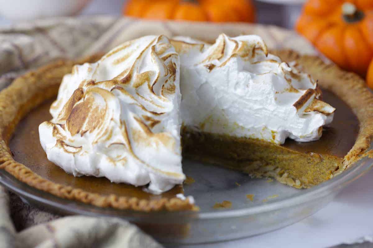 Pumpkin meringue pie sliced to show the filling inside