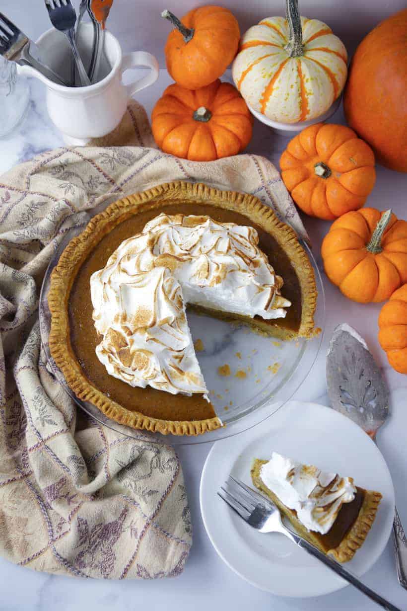 Pumpkin pie serving on a plate with fork