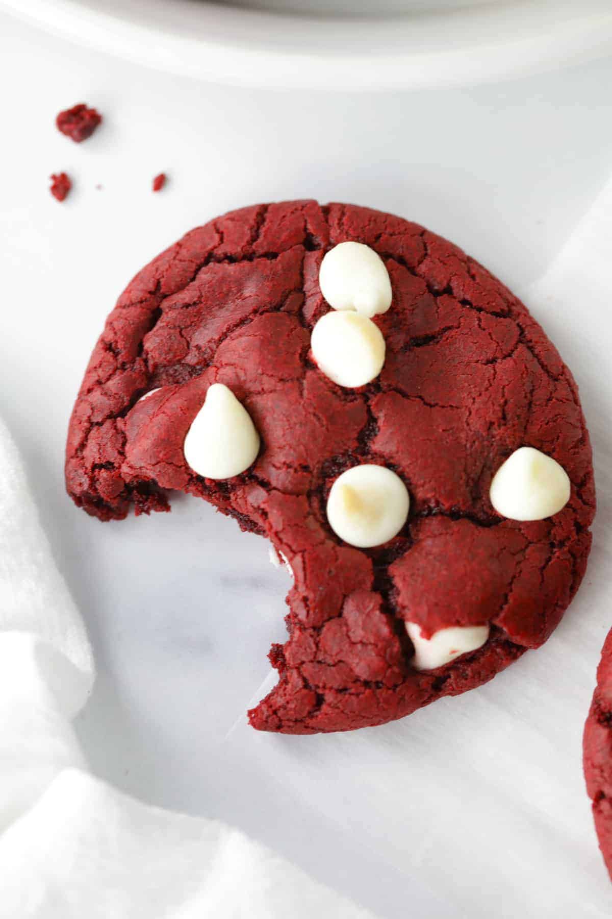 One red velvet cake mix cookie with a bite taken out.