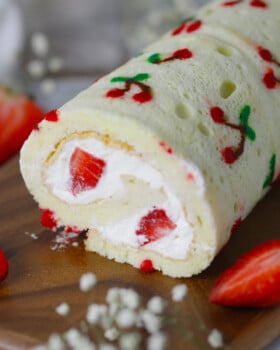 Vanilla cake roll with cherry design on the top.