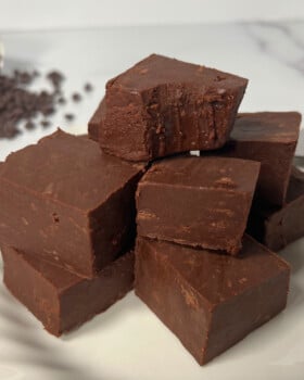 White plate with stack of seven cubes of homemade fudge.