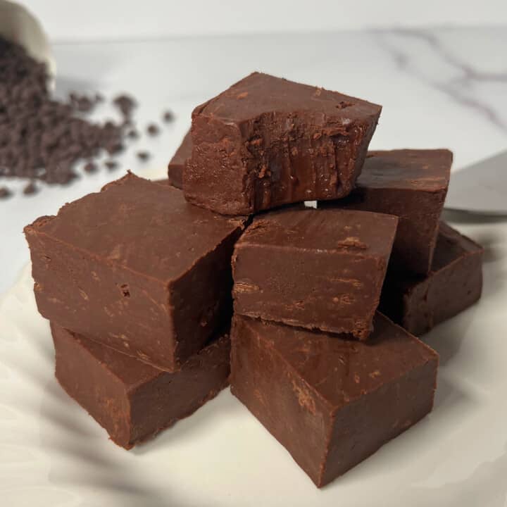 White plate with stack of seven cubes of homemade fudge.