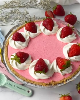 Cool whip pie in graham cracker crust with strawberries on top.