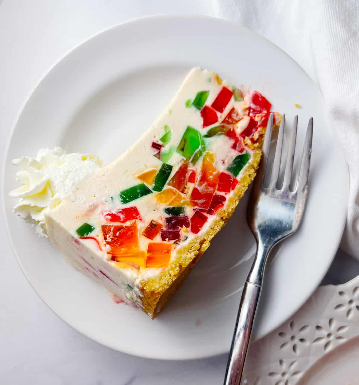 Prism cake on a white plate with fork.