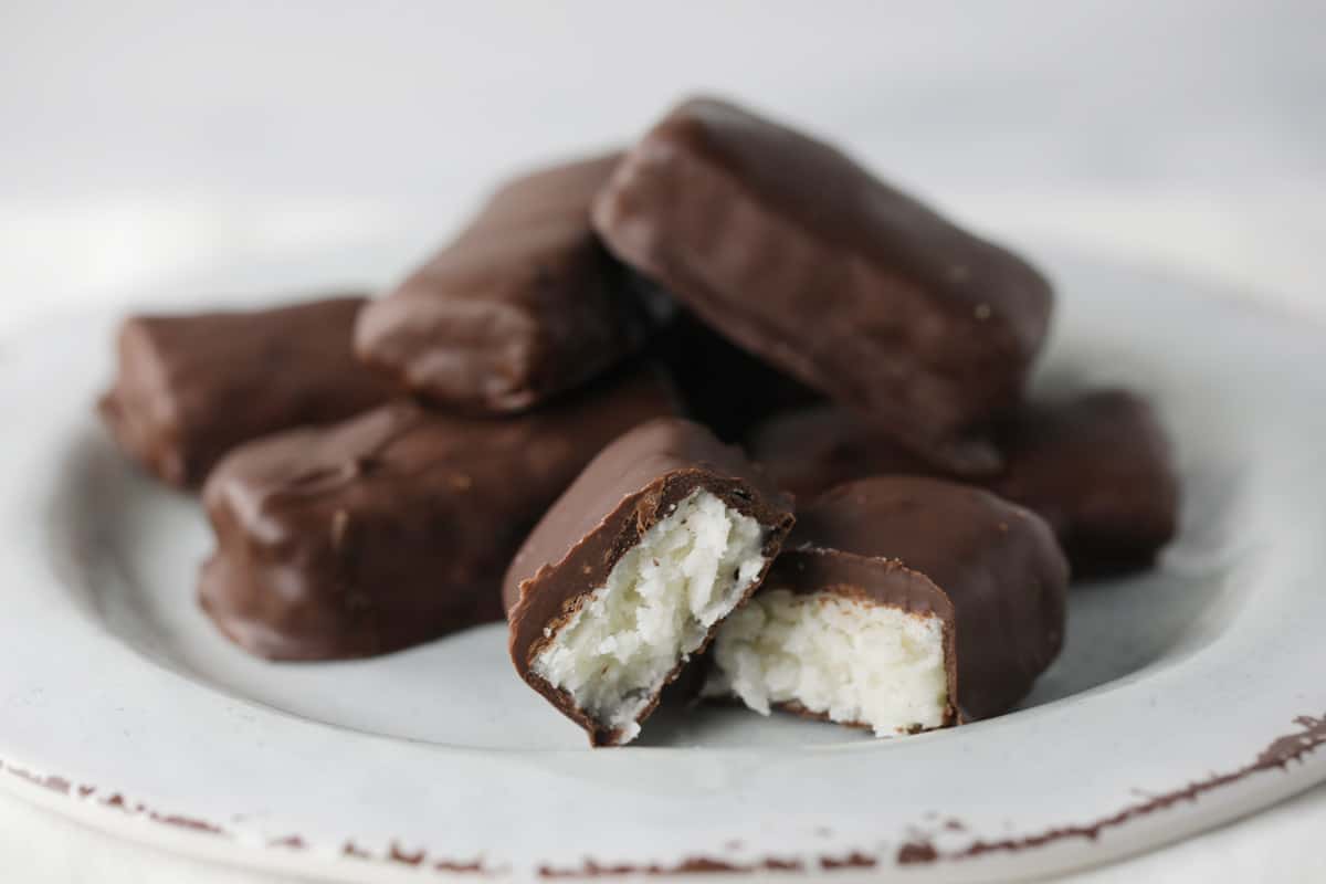 White plate full of chocolate coconut bars.