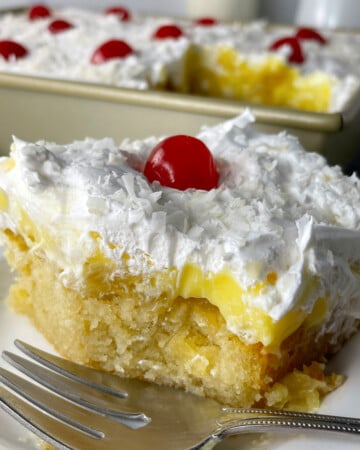 Slice of pineapple poke cake.