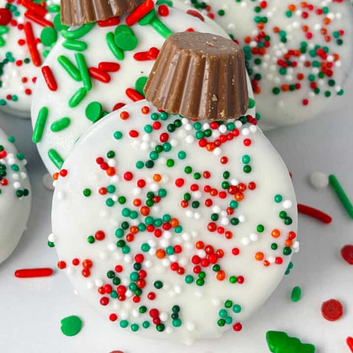 One oreo cookie dipped in white chocolate candy melts and decorated like an ornament.