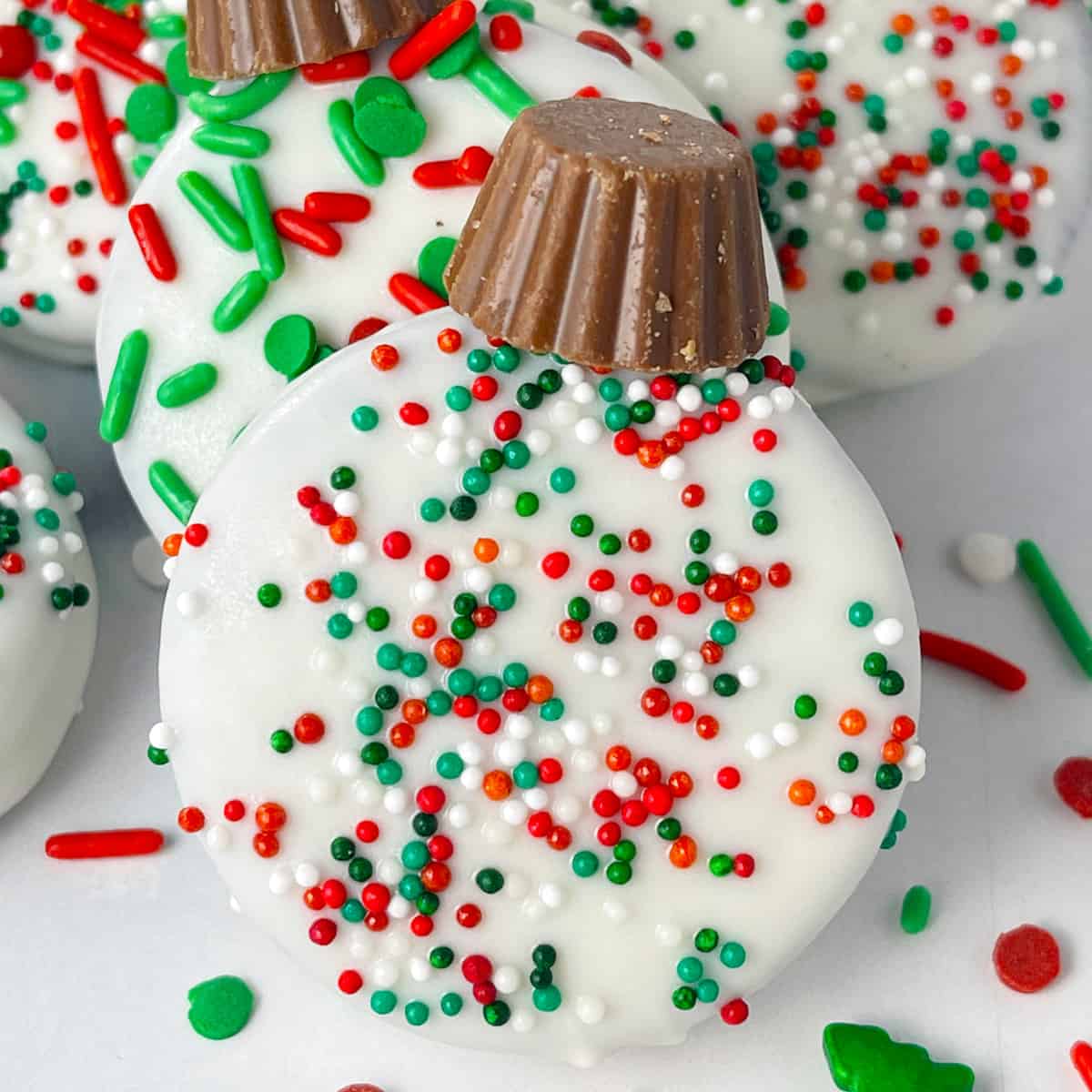 One oreo cookie dipped in white chocolate candy melts and decorated like an ornament.