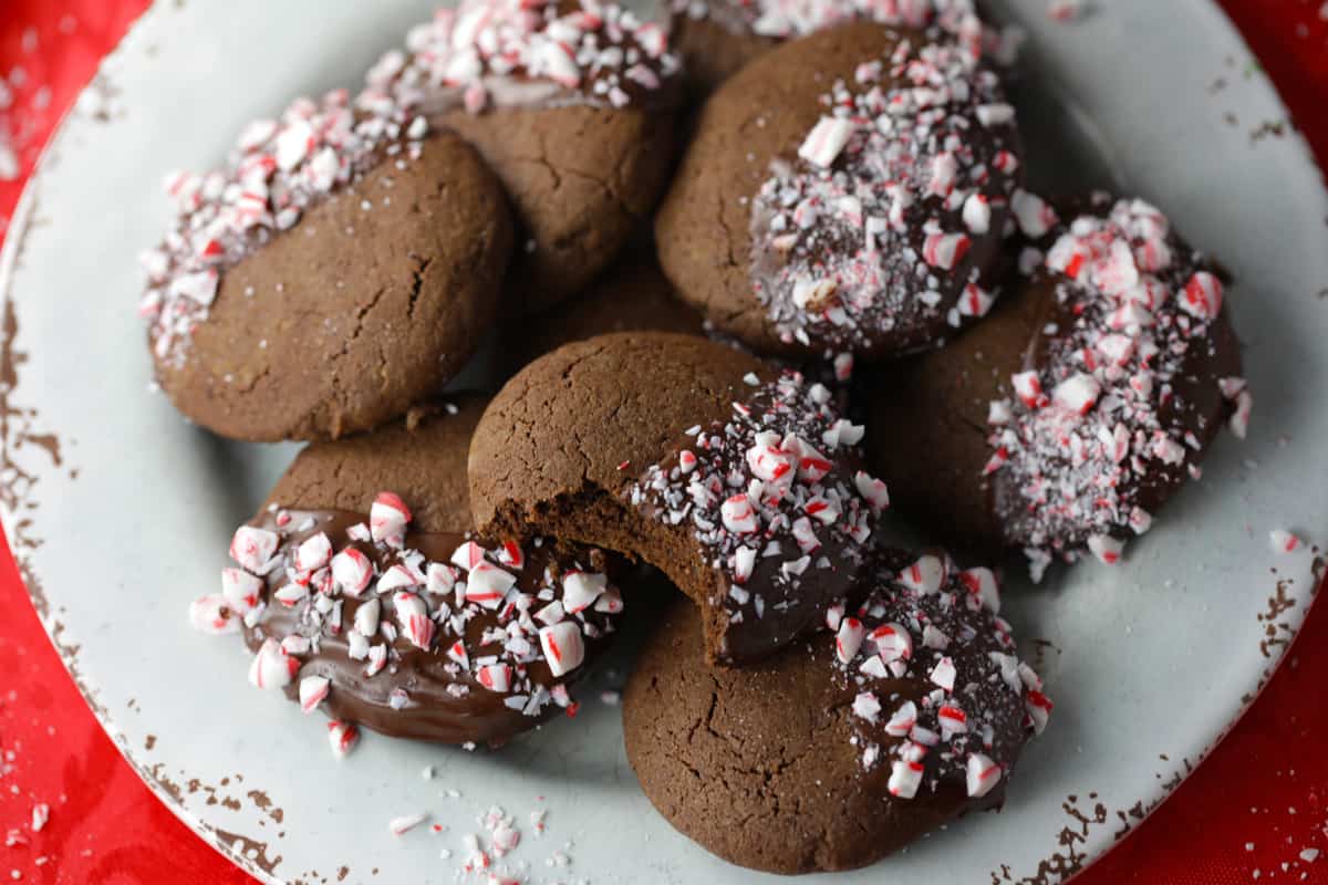 Easy gluten free chocolate dipped peppermint cookies on a white plate.