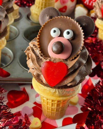 Adorable teddy bear cupcake made in an ice cream cone with heart.